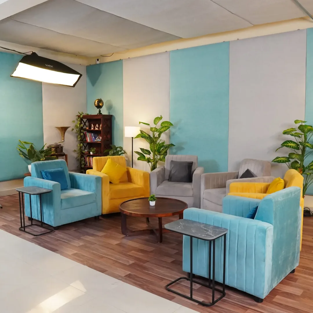 Podcast studio in bangalore with vibrant-coloured sofas