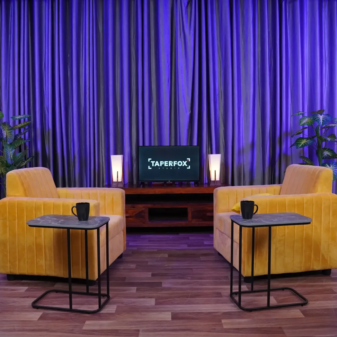 Podcast studio setup with yellow sofa and purple background